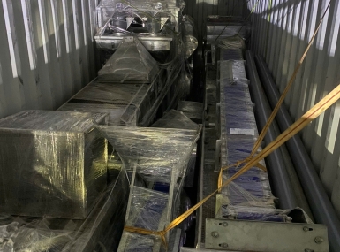 Packing a container of processing machinery for shipment to Tanzania.